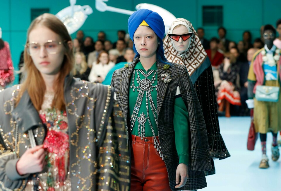 FILE - In this Feb. 21, 2018 file photo, models display items from Gucci's women's Fall/Winter 2018-2019 collection, presented during the Milan Fashion Week, in Milan, Italy. The top civil rights organization for Sikhs in the United States says Nordstrom has apologized to the community for selling an $800 turban they found offensive, but they are still waiting to hear from the Gucci brand that designed it, Saturday, May 18, 2019. (AP Photo/Antonio Calanni, File)