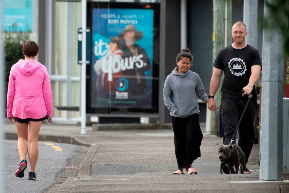Pedestrians practise social distancing in response to the COVID-19 coronavirus outbreak along a street of Lower Hutt, near Wellington, on April 20, 2020. - New Zealand will ease a nationwide COVID-19 lockdown next week after claiming success in stopping 'an uncontrolled explosion' of the virus, Prime Minister Jacinda Ardern said on April 20. (Photo by Marty MELVILLE / AFP) Pedestrians practise social distancing in response to the COVID-19 coronavirus outbreak along a street of Lower Hutt, near Wellington, on April 20, 2020. - New Zealand will ease a nationwide COVID-19 lockdown next week after claiming success in stopping 'an uncontrolled explosion' of the virus, Prime Minister Jacinda Ardern said on April 20. (Photo by Marty MELVILLE / AFP)