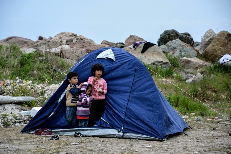 Children stand outside a tent in the village of Petra on the northeastern Aegean island of Lesbos, Greece, Friday, March 27, 2020. Some 56 migrants who reached Lesbos in smugglers' boats from Turkey over the past few days have been quarantined in small tents in Petra for the past three days. Under public health measures adopted to hinder the spread of the new coronavirus, Greece places all people arriving from abroad in two-week quarantine. Lesbos' main migrant facility, near the village of Moria, is crammed with about 20,000 people even though it was built for 2,700. (AP Photo/Panagiotis Balaskas) Children stand outside a tent in the village of Petra on the northeastern Aegean island of Lesbos, Greece, Friday, March 27, 2020. Some 56 migrants who reached Lesbos in smugglers' boats from Turkey over the past few days have been quarantined in small tents in Petra for the past three days. Under public health measures adopted to hinder the spread of the new coronavirus, Greece places all people arriving from abroad in two-week quarantine. Lesbos' main migrant facility, near the village of Moria, is crammed with about 20,000 people even though it was built for 2,700. (AP Photo/Panagiotis Balaskas)