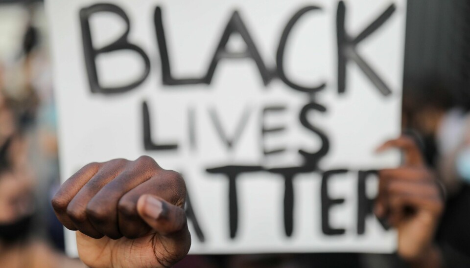 A person carries a banner during a protest against the death in Minneapolis police custody of George Floyd, in front of a U.S. consulate, in Barcelona, Spain June 1, 2020. REUTERS/Nacho Doce