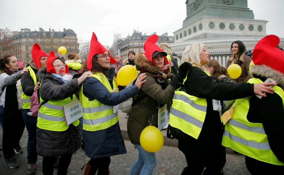PROTEST: De gule vestene er ikke imot klimaet, men mener kostnadene for det grønne skiftet må fordeles rettferdig. De røde luene symboliserer den franwske revolusjonen. FOTO: MICHEL EULER/NTB SCANPIX