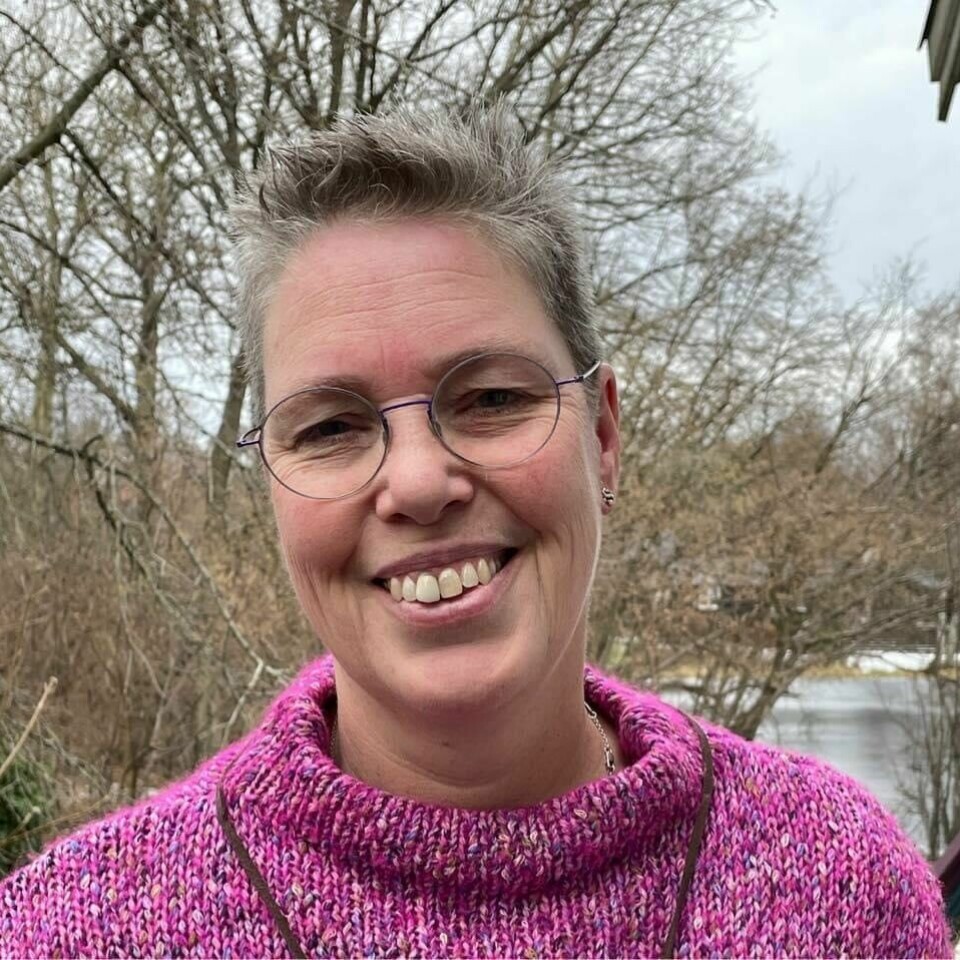 Anneke Dapper-Skaaning er forfatteren av boken Demenssprog. Kvinne rundt 50 år med kort, grått hår og en rosa genser.