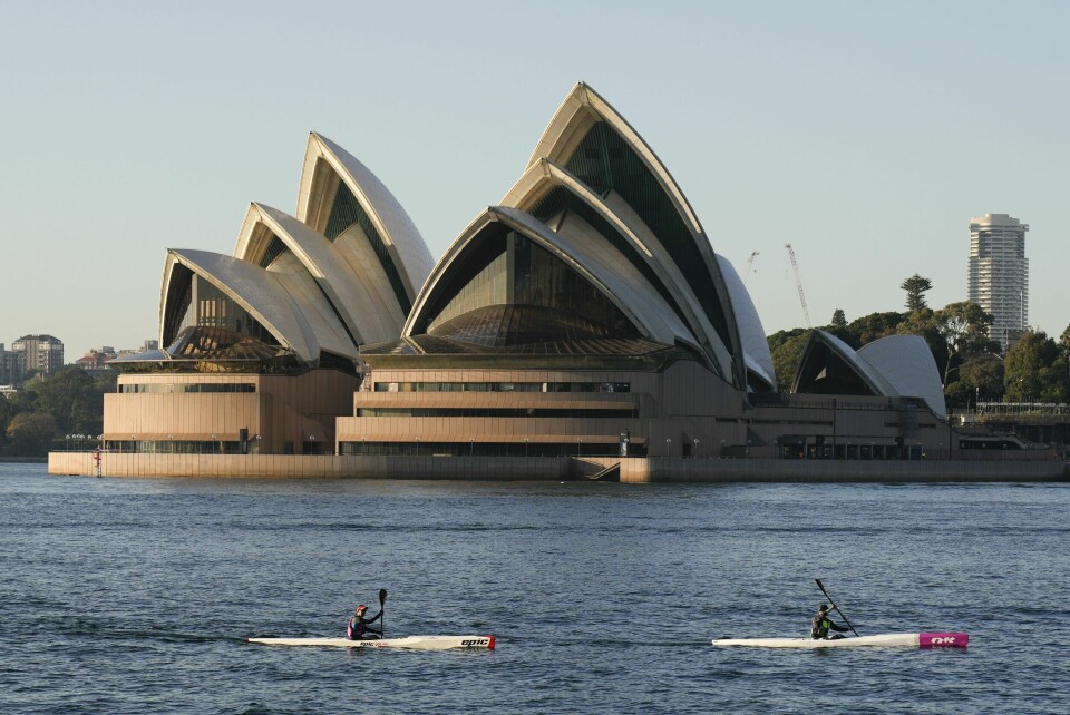 Illustrasjonsbilde. Kayakers paddle past the Sydney Opera House on Sydney Harbour.
