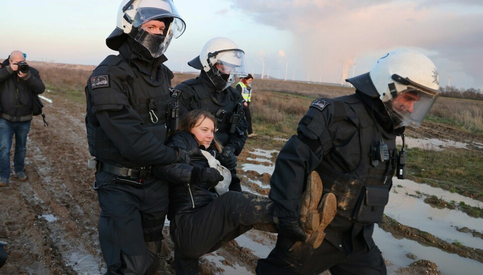 Tre politifolk bar bort Gretha Thunberg ved kullgruven Garzweiler II tirsdag. Foto: Federico Gambarini / DPA / AP / NTB Tre politifolk bar bort Gretha Thunberg ved kullgruven Garzweiler II tirsdag. Foto: Federico Gambarini / DPA / AP / NTB