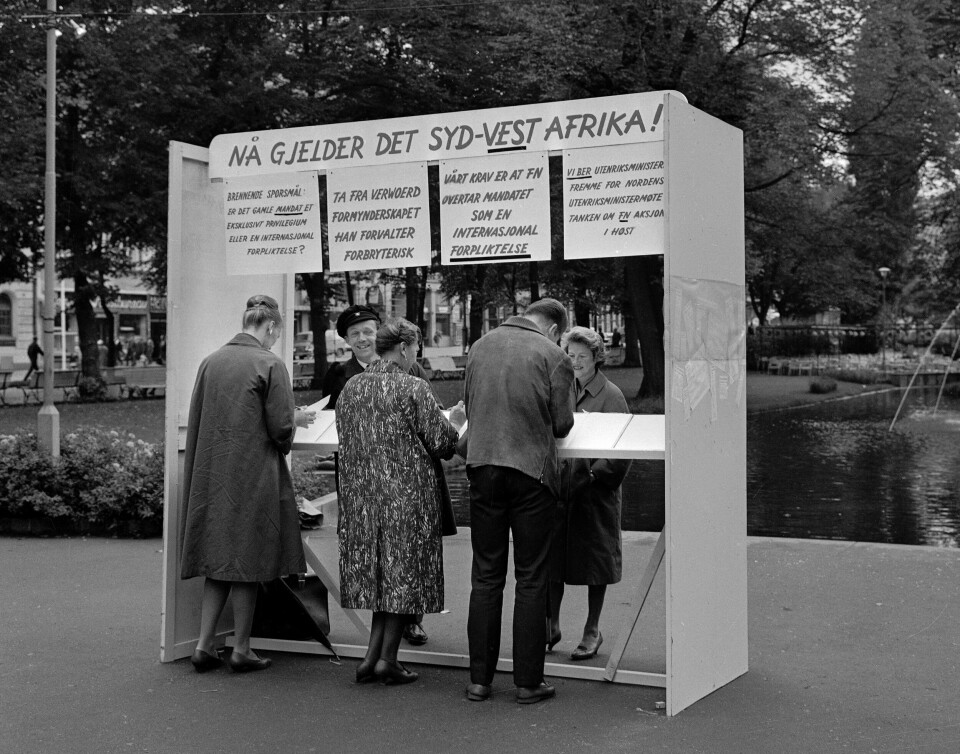 Innføringen av apartheid i Sør-Afrika førte til store protester over heleverden. Her samles underskrifter mot apartheidregimet i Studenterlunden i august 1963. To personer står i en bod og samler inn underskrifter fra forbipasserende.