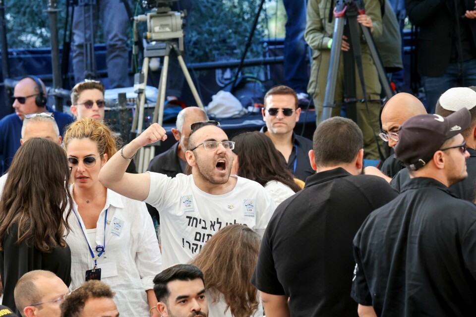 En demonstrant roper mot statsminister Benjamin Netanyah som taler i en minneseremoni for Hamas-angrepet i fjor. Demonstrantene krever at gislene settes fri. En demonstrant roper mot statsminister Benjamin Netanyah som taler i en minneseremoni for Hamas-angrepet i fjor. Demonstrantene krever at gislene settes fri. Foto: Gil Cohen-Magen / AP / NTB