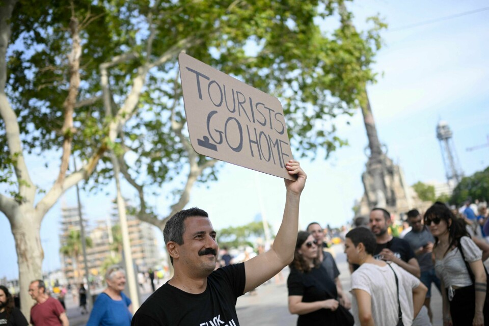 En spanjol protesterer mot masseturismen i Barcelona i juli denne sommeren. En spanjol protesterer mot masseturismen i Barcelona i juli denne sommeren.