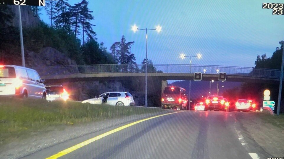 Maskerte personer sperret E18 i forkant av kappkjøringen i juni 2023. Bildet er fra en video tatt av UP. I dag ble det kjent at Høyesterett har gitt påtalemyndigheten medhold i at en bil kan inndras etter ulovlig kappkjøring på E18 ved Liertoppen i fjor. Politiet reagerte kraftig på den organiserte kappkjøringen på E18 i fjor sommer, der maskerte personer sperret E18 i forkant. Bildet er fra en video tatt av UP. Foto: Utrykningspolitiet / NTB