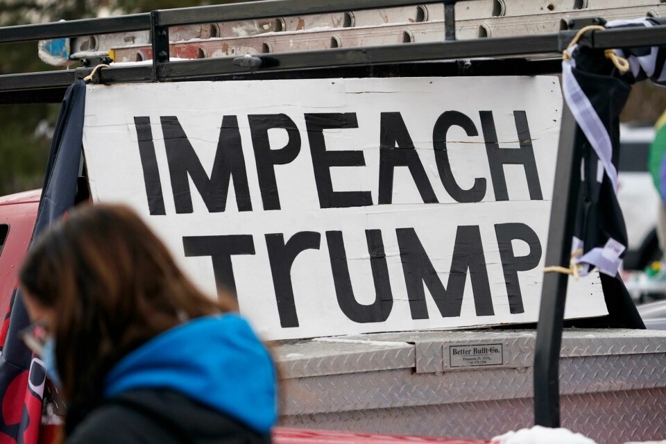 A sign stands in the bed of a pickup truck during a gathering calling for the impeachment of President Donald Trump at South High School before a car rally through the streets of downtown Sunday, Jan. 10, 2021, in Denver. More than 150 vehicles were guided by motorists calling for the removal from office of Trump as well as the resignations of Colorado Republican U.S. Representatives Lauren Boebert and Doug Lanborn for their support of Trump. (AP Photo/David Zalubowski) A sign stands in the bed of a pickup truck during a gathering calling for the impeachment of President Donald Trump at South High School before a car rally through the streets of downtown Sunday, Jan. 10, 2021, in Denver. More than 150 vehicles were guided by motorists calling for the removal from office of Trump as well as the resignations of Colorado Republican U.S. Representatives Lauren Boebert and Doug Lanborn for their support of Trump. (AP Photo/David Zalubowski)