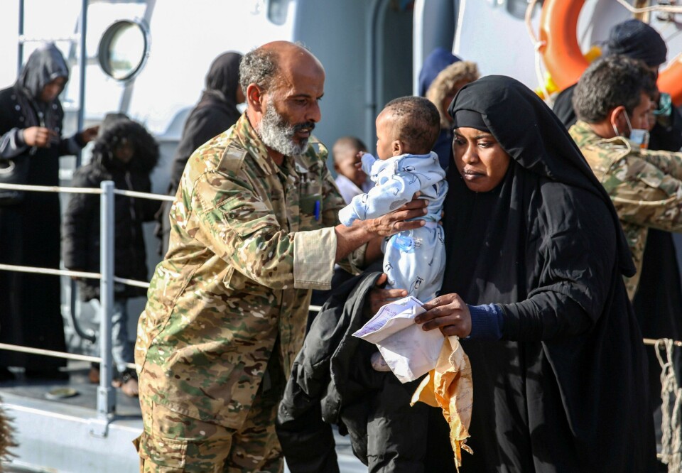 Migrants rescued off the coast of al-Khums, about 120 kilometres east of the capital, disembark off a Libyan coastguard vessel onto the pier in Tripoli's naval base on February 10, 2021. (Photo by - / AFP) Migrants rescued off the coast of al-Khums, about 120 kilometres east of the capital, disembark off a Libyan coastguard vessel onto the pier in Tripoli's naval base on February 10, 2021. (Photo by - / AFP)