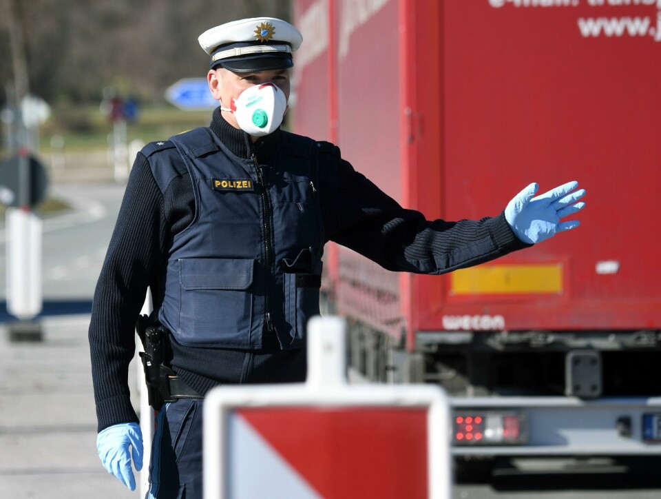 A German police officer, wearing a face mask, stops a driver at the border crossing between Austria and Germany, near the German village of Oberaudorf, as Germany imposes border controls with five countries in a virus fightback, on March 16, 2020. - Germany introduced border controls with Austria, Denmark, France, Luxembourg and Switzerland in a bid to stem the coronavirus outbreak. Only those with a valid reason for travel, like cross-border commuters and delivery drivers, are allowed through, officials said. (Photo by Christof STACHE / AFP) A German police officer, wearing a face mask, stops a driver at the border crossing between Austria and Germany, near the German village of Oberaudorf, as Germany imposes border controls with five countries in a virus fightback, on March 16, 2020. - Germany introduced border controls with Austria, Denmark, France, Luxembourg and Switzerland in a bid to stem the coronavirus outbreak. Only those with a valid reason for travel, like cross-border commuters and delivery drivers, are allowed through, officials said. (Photo by Christof STACHE / AFP)