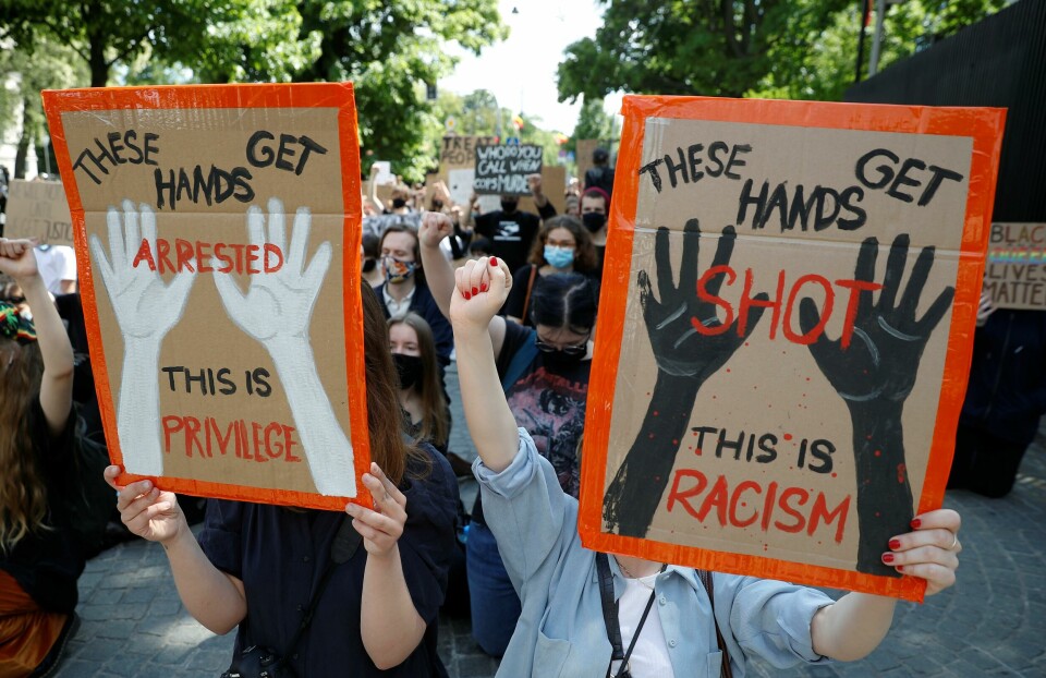 Demonstrators hold signs during a protest over police brutality towards African-Americans in the United States, after the death of George Floyd in Minneapolis police custody, in front of the U.S. embassy in Warsaw, Poland, June 4, 2020. REUTERS/Kacper Pempel Demonstrators hold signs during a protest over police brutality towards African-Americans in the United States, after the death of George Floyd in Minneapolis police custody, in front of the U.S. embassy in Warsaw, Poland, June 4, 2020. REUTERS/Kacper Pempel