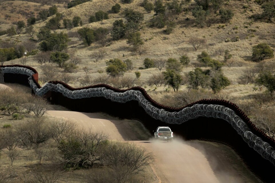 FILE - This March 2, 2019 photo shows a Customs and Border Control agent patrols on the US side of a razor-wire-covered border wall along the Mexico east of Nogales, Ariz. A surge of asylum-seeking families that has strained cities along the southern U.S. border for months is now being felt in cities far from Mexico. Immigrants are being housed in airplane hangars and rodeo fairgrounds, while local authorities are struggling to keep up with the influx.(AP Photo/Charlie Riedel) FILE - This March 2, 2019 photo shows a Customs and Border Control agent patrols on the US side of a razor-wire-covered border wall along the Mexico east of Nogales, Ariz. A surge of asylum-seeking families that has strained cities along the southern U.S. border for months is now being felt in cities far from Mexico. Immigrants are being housed in airplane hangars and rodeo fairgrounds, while local authorities are struggling to keep up with the influx.(AP Photo/Charlie Riedel)