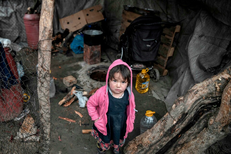 A child looks on from its family shelter at the overcrowded Moria migrant camp on the island of Lesbos, on March 5, 2020. - Greece's defence ministry on March 5 announced a week-long shipping ban around Aegean islands facing a migration surge from Turkey, excepting only EU and NATO patrol vessels and registered commercial ships. Greece is attempting to hold back a migration surge by land and sea from neighbouring Turkey that began last week after Ankara said it would no longer stop asylum seekers from entering Europe. (Photo by LOUISA GOULIAMAKI / AFP) A child looks on from its family shelter at the overcrowded Moria migrant camp on the island of Lesbos, on March 5, 2020. - Greece's defence ministry on March 5 announced a week-long shipping ban around Aegean islands facing a migration surge from Turkey, excepting only EU and NATO patrol vessels and registered commercial ships. Greece is attempting to hold back a migration surge by land and sea from neighbouring Turkey that began last week after Ankara said it would no longer stop asylum seekers from entering Europe. (Photo by LOUISA GOULIAMAKI / AFP)