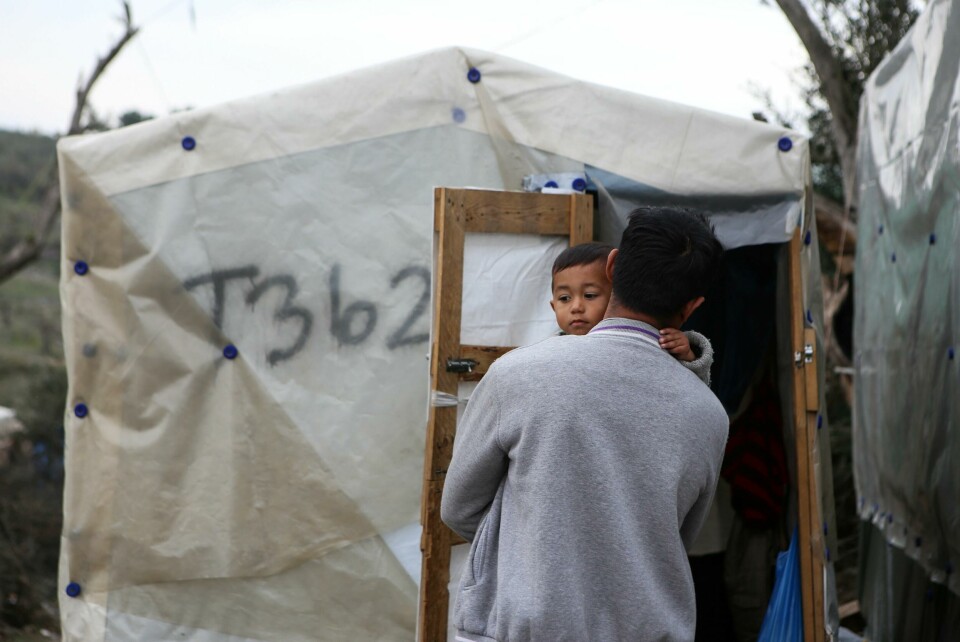 A man holds his son outside their shelter at a makeshift camp for refugees and migrants next to the Moria camp, on the island of Lesbos, Greece, March 9, 2020. REUTERS/Elias Marcou A man holds his son outside their shelter at a makeshift camp for refugees and migrants next to the Moria camp, on the island of Lesbos, Greece, March 9, 2020. REUTERS/Elias Marcou