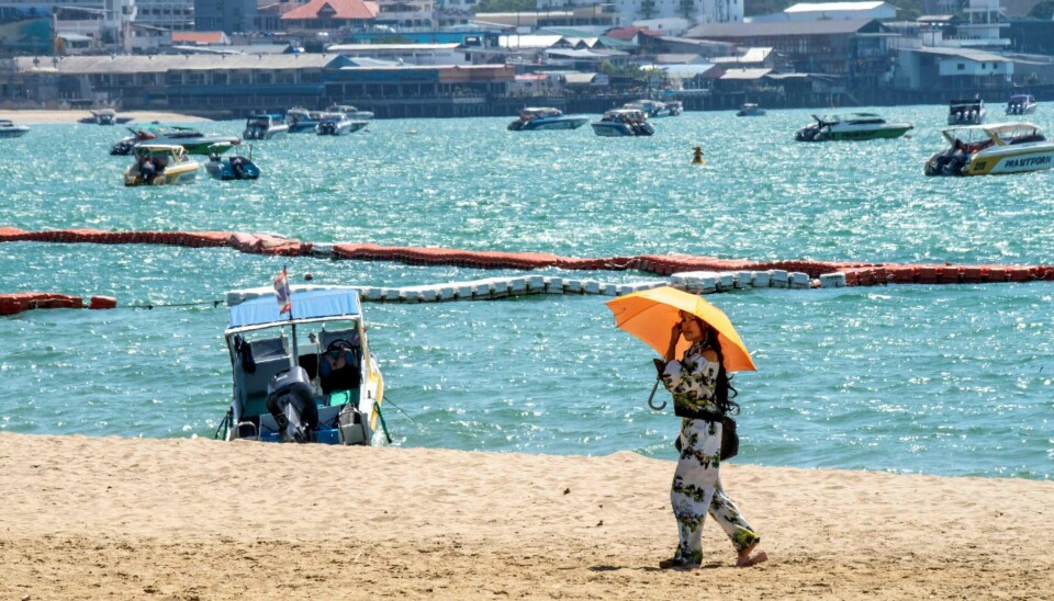 A tourist walks on an empty beach in Pattaya on March 7, 2020, as visitor numbers in the region have plunged due to the outbreak of the COVID-19 coronavirus. (Photo by Mladen ANTONOV / AFP)