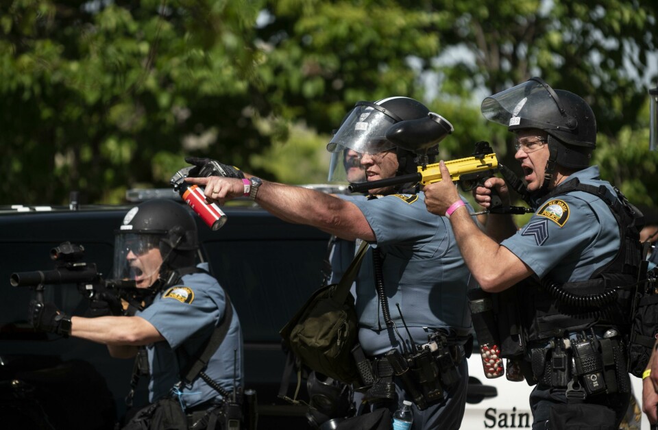 ST. PAUL, MN - MAY 28: Police aim their weapons at protesters in the parking lot of a Target store on May 28, 2020 in St. Paul, Minnesota. Police and protesters continued to clash for a third night after George Floyd was killed in police custody on Monday. Stephen Maturen/Getty Images/AFP== FOR NEWSPAPERS, INTERNET, TELCOS & TELEVISION USE ONLY == ST. PAUL, MN - MAY 28: Police aim their weapons at protesters in the parking lot of a Target store on May 28, 2020 in St. Paul, Minnesota. Police and protesters continued to clash for a third night after George Floyd was killed in police custody on Monday. Stephen Maturen/Getty Images/AFP== FOR NEWSPAPERS, INTERNET, TELCOS & TELEVISION USE ONLY ==