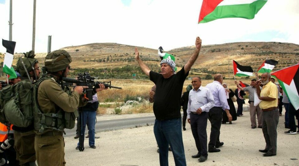 Det er 50 år siden blant annet Vestbredden ble okkupert av Israel. Her en palestinsk demonstrant som konfronterer en israelsk soldat på Vestbredden. FOTO: JAAFAR ASHTIYEH/NTB SCANPIX