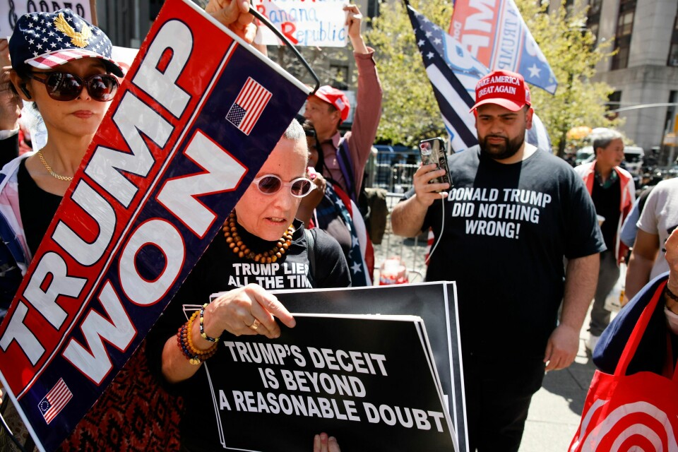 EN motdemonstrant snek seg tidligere i måneden inn blant Donald Trump-tilhengere som hadde tatt oppstilling utenfor rettslokalet i New York der han står tiltalt for å ha betalt såkalte hysjpenger til en tidligere pornoskuespiller. EN motdemonstrant snek seg tidligere i måneden inn blant Donald Trump-tilhengere som hadde tatt oppstilling utenfor rettslokalet i New York der han står tiltalt for å ha betalt såkalte hysjpenger til en tidligere pornoskuespiller. Foto: AP / NTB
