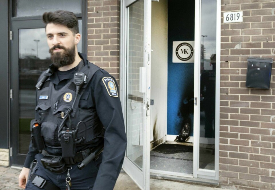 En politimann ved inngangen til en jødisk institusjon i Montreal mandag. Inngangspartiet bærer tydelig preg av at en brannbombe er kastet inn. Canada Jewish Centre FirebombA police officer leaves from the entrance of a Jewish community centre Monday, Nov. 27, 2023, in Montreal. Montreal police are investigating after an incendiary object was allegedly thrown against the door of a Jewish community centre early this morning. (Ryan Remiorz/The Canadian Press via AP)