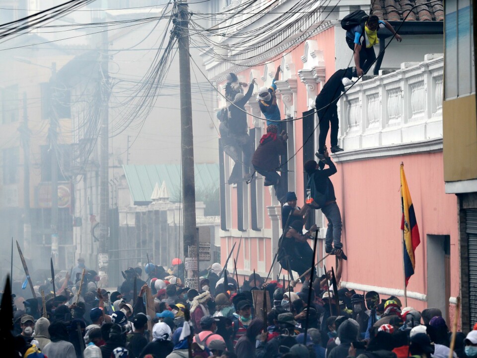 Anti-government demonstrators scale the facade of a residence to reach the rooftop, looking for a better vantage point to battle with police, in Quito, Ecuador, Friday, Oct. 11, 2019. Protests, which began when President Lenin Moreno's decision to cut subsidies led to a sharp increase in fuel prices, persisted for days. (AP Photo/Dolores Ochoa) Anti-government demonstrators scale the facade of a residence to reach the rooftop, looking for a better vantage point to battle with police, in Quito, Ecuador, Friday, Oct. 11, 2019. Protests, which began when President Lenin Moreno's decision to cut subsidies led to a sharp increase in fuel prices, persisted for days. (AP Photo/Dolores Ochoa)
