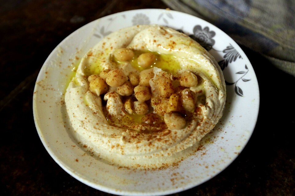 A plate of Hummus is served at a restaurant in the Lebanese coastal city of Tripoli, north of Beirut on October 20, 2014. Hummus is a Levantine food dip or spread made from mashed chickpeas blended with tahini, olive oil, lemon juice, salt and garlic. Today, it is popular throughout the Middle East, North Africa, and in Middle Eastern cuisine around the globe. AFP PHOTO/JOSEPH EID A plate of Hummus is served at a restaurant in the Lebanese coastal city of Tripoli, north of Beirut on October 20, 2014. Hummus is a Levantine food dip or spread made from mashed chickpeas blended with tahini, olive oil, lemon juice, salt and garlic. Today, it is popular throughout the Middle East, North Africa, and in Middle Eastern cuisine around the globe. AFP PHOTO/JOSEPH EID