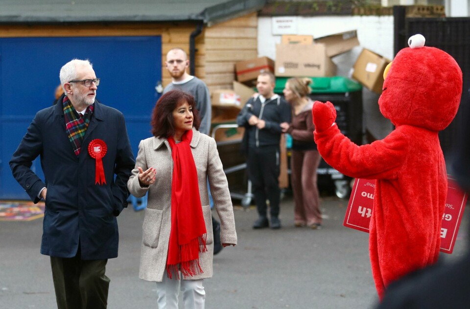Britain's opposition Labour Party leader Jeremy Corbyn and his wife Laura Alvarez look on as a person in a costume of Sesame Street character Elmo waves, as they arrive at a polling station to vote in the general election in London, Britain, December 12, 2019. REUTERS/Hannah McKay Britain's opposition Labour Party leader Jeremy Corbyn and his wife Laura Alvarez look on as a person in a costume of Sesame Street character Elmo waves, as they arrive at a polling station to vote in the general election in London, Britain, December 12, 2019. REUTERS/Hannah McKay