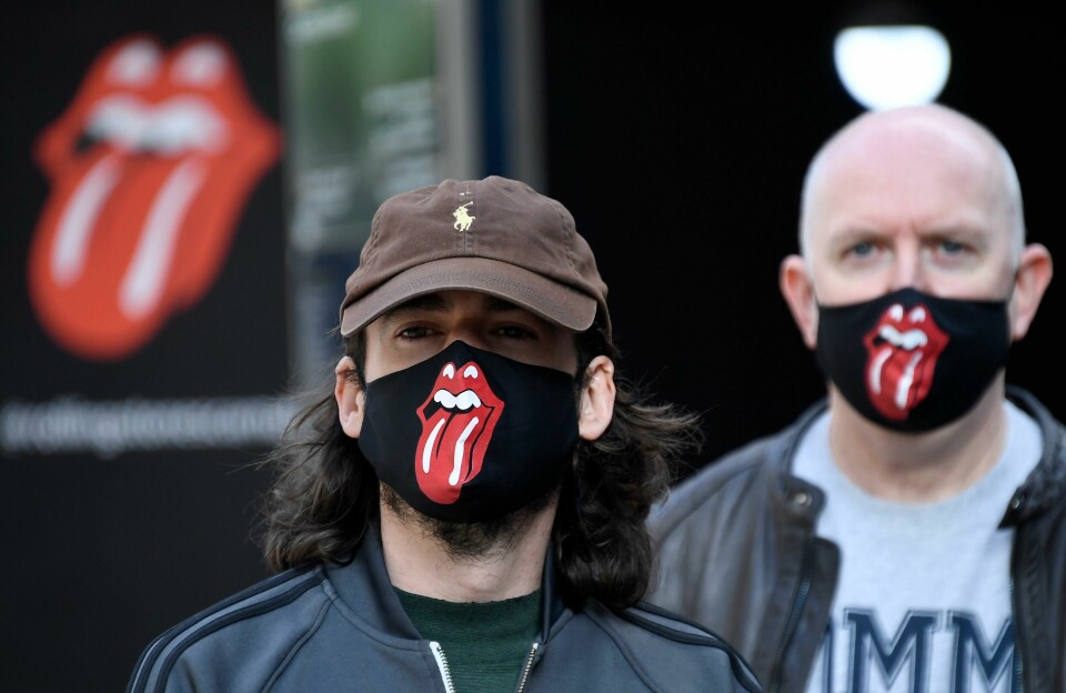 Rolling Stones fans wear face masks as they queue during the opening of Rolling Stones flagship store in London, Wednesday, Sept. 9, 2020. The shop will sell fashion and merchandise, as well as music, from the famous rock band. (AP Photo/Alberto Pezzali) Rolling Stones fans wear face masks as they queue during the opening of Rolling Stones flagship store in London, Wednesday, Sept. 9, 2020. The shop will sell fashion and merchandise, as well as music, from the famous rock band. (AP Photo/Alberto Pezzali)