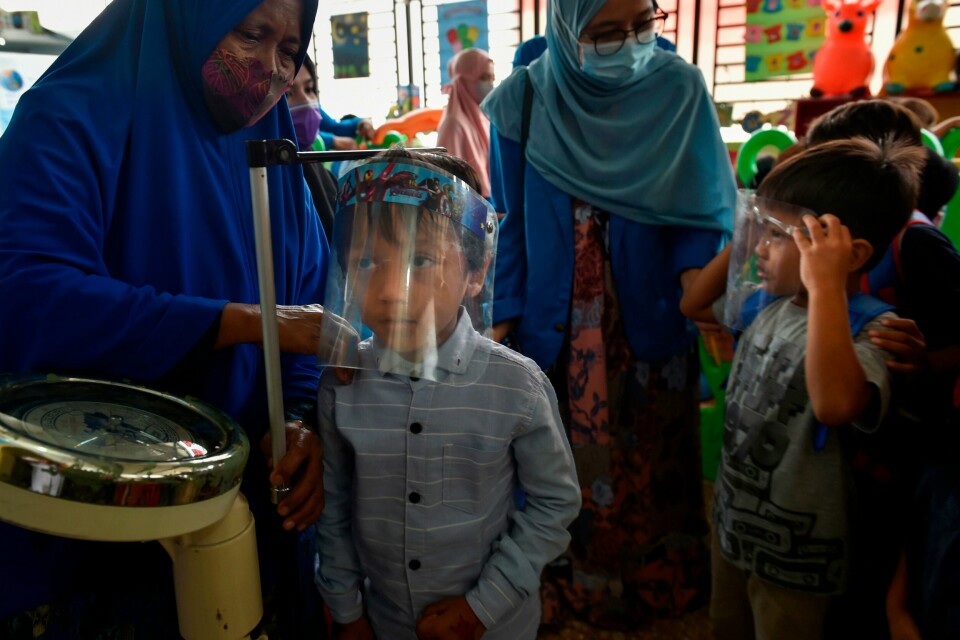 A child's measurements are taken before receiving the measles and polio vaccines at a service post in Banda Aceh on November 4, 2020. (Photo by CHAIDEER MAHYUDDIN / AFP) A child's measurements are taken before receiving the measles and polio vaccines at a service post in Banda Aceh on November 4, 2020. (Photo by CHAIDEER MAHYUDDIN / AFP)