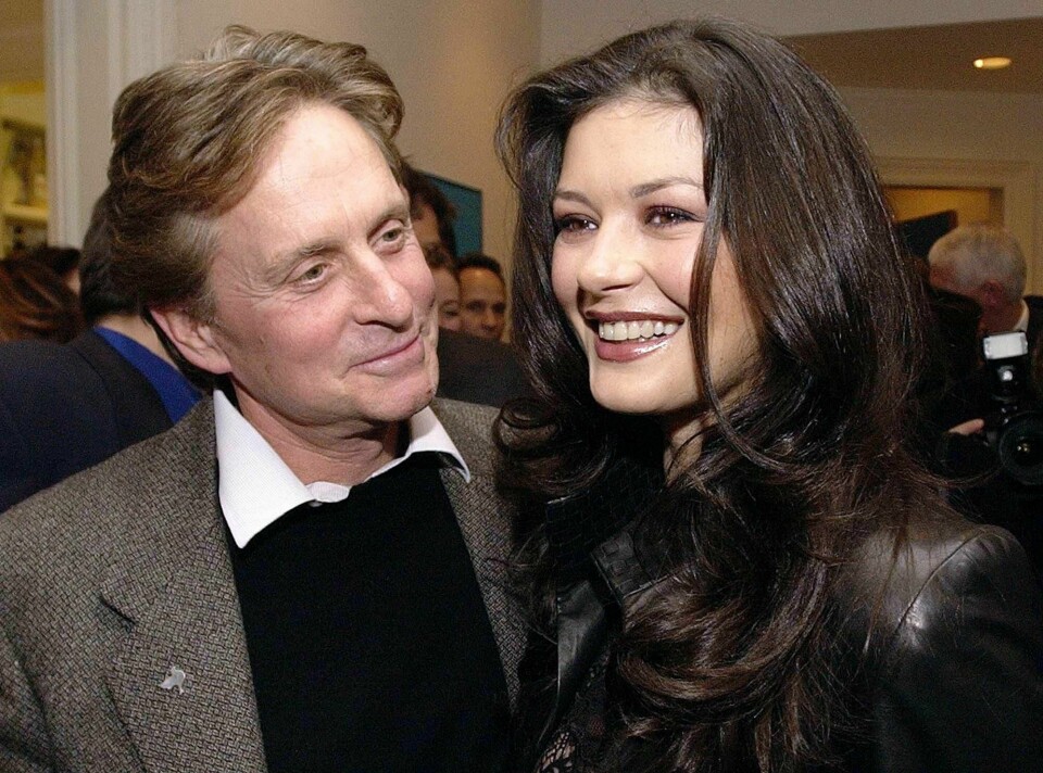 Actors Michael Douglas, left, and wife Catherine Zeta-Jones smile at a private party in honor of former South African President Nelson Mandela in Toronto Saturday, Nov. 17, 2001. Mandela and his wife, Graca Machel, were in Toronto for a brief weekend visit to receive honorary doctorates of laws from Ryerson for their work with children. (AP Photo/CP, Aaron Harris)