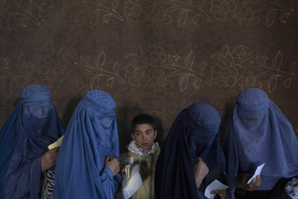 Afghanske kvinner venter i kø for å motta penger fra Verdens Matvareprogram. Afghanske kvinner er pålagt å bære den heldekkende burkaen under Talibans regime. Amnesty Internasjonal kritiserer Taliban for å knuse kvinners og jenters rettigheter, og ber det internasjonale samfunnet prøve å hjelpe kvinnene i landet. Foto: AP / NTB