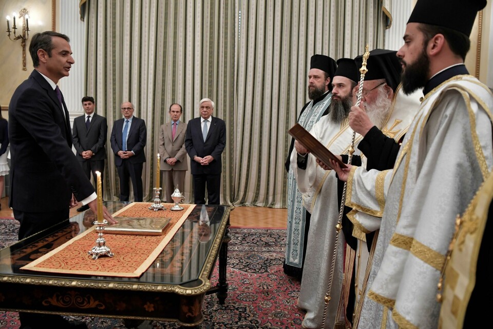Greece's newly elected Prime Minister Kyriakos Mitsotakis (L) is sworn-in at the presidential palace in Athens on July 8, 2019. - Greece's new prime minister, Kyriakos Mitsotakis, formally takes up the reins on July 8, a day after an election victory that puts him in charge of the EU's most indebted member with promises to end a decade of economic crisis. (Photo by Louisa GOULIAMAKI / AFP) Greece's newly elected Prime Minister Kyriakos Mitsotakis (L) is sworn-in at the presidential palace in Athens on July 8, 2019. - Greece's new prime minister, Kyriakos Mitsotakis, formally takes up the reins on July 8, a day after an election victory that puts him in charge of the EU's most indebted member with promises to end a decade of economic crisis. (Photo by Louisa GOULIAMAKI / AFP)