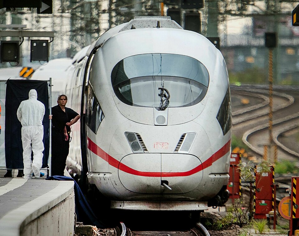 Police officers and rescue workers recover a body under an ICE highspeed train at the main station in Frankfurt, Germany, Monday, July 29, 2019. An 8-year-old boy was run over by a train and killed at Frankfurt's main station on Monday after a man pushed him and his mother onto the tracks. The mother was able to escape but the boy was hit and run over by the train and suffered fatal injuries. (AP Photo/Michael Probst) Police officers and rescue workers recover a body under an ICE highspeed train at the main station in Frankfurt, Germany, Monday, July 29, 2019. An 8-year-old boy was run over by a train and killed at Frankfurt's main station on Monday after a man pushed him and his mother onto the tracks. The mother was able to escape but the boy was hit and run over by the train and suffered fatal injuries. (AP Photo/Michael Probst)