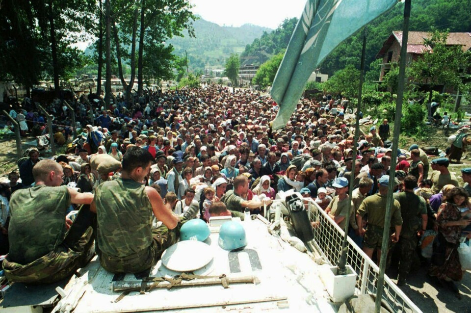 FILE - In this July 13, 1995 file photo, Dutch U.N. peacekeepers sit on top of an armored personnel carrier while Muslim refugees from Srebrenica, eastern Bosnia, gather in the village of Potocari, just north of Srebrenica. The Dutch Supreme Court is ruling Friday July 19, 2019 in a long-running legal battle over whether the Netherlands can be held liable in the deaths of more than 300 Muslim men who were murdered by Bosnian Serb forces during the 1995 Srebrenica massacre. (AP Photo/File) FILE - In this July 13, 1995 file photo, Dutch U.N. peacekeepers sit on top of an armored personnel carrier while Muslim refugees from Srebrenica, eastern Bosnia, gather in the village of Potocari, just north of Srebrenica. The Dutch Supreme Court is ruling Friday July 19, 2019 in a long-running legal battle over whether the Netherlands can be held liable in the deaths of more than 300 Muslim men who were murdered by Bosnian Serb forces during the 1995 Srebrenica massacre. (AP Photo/File)
