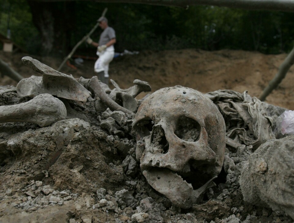 FILE - A July, 10, 2007 file photo shows a Bosnian worker passing by a human skull during exhumation at a mass grave site in a village of Budak, near Srebrenica, Bosnia-Herzegovina. Former Bosnian Serb Army chief Ratko Mladic will learn his fate on Nov. 22, 2017, when U.N. judges deliver verdicts in his genocide and war crimes trial. (AP Photo/Amel Emric, File) FILE - A July, 10, 2007 file photo shows a Bosnian worker passing by a human skull during exhumation at a mass grave site in a village of Budak, near Srebrenica, Bosnia-Herzegovina. Former Bosnian Serb Army chief Ratko Mladic will learn his fate on Nov. 22, 2017, when U.N. judges deliver verdicts in his genocide and war crimes trial. (AP Photo/Amel Emric, File)