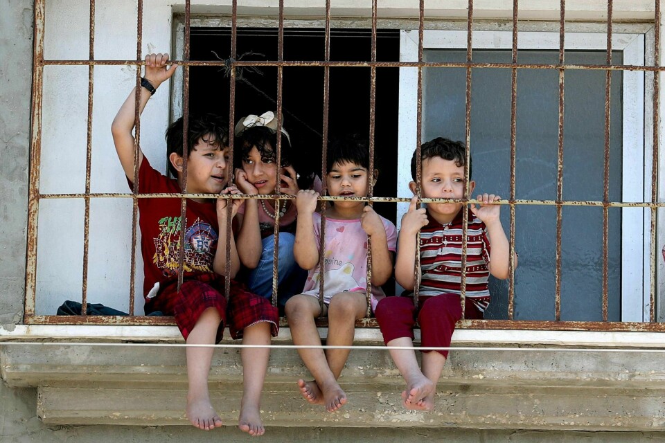 Children watch a rally through a home window fence as Palestinians call for a 'day of rage' to protest against Israel's plan to annex parts of the Israeli-occupied West Bank, in Gaza City July 1, 2020. REUTERS/Mohammed Salem TPX IMAGES OF THE DAY