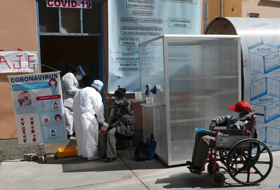 Healthcare workers dressed in full protective gear tend to people who they suspect may be infected with COVID-19, at the General Hospital in La Paz, Bolivia, Wednesday, July 22, 2020. (AP Photo/Juan Karita) Healthcare workers dressed in full protective gear tend to people who they suspect may be infected with COVID-19, at the General Hospital in La Paz, Bolivia, Wednesday, July 22, 2020. (AP Photo/Juan Karita)