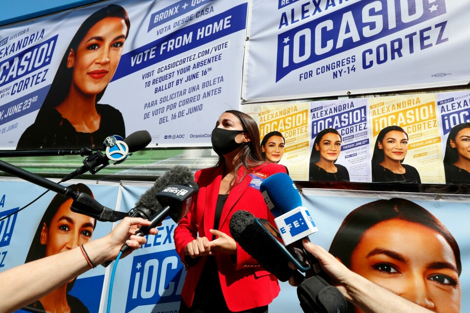 U.S. Rep. Alexandria Ocasio-Cortez, D, New York, center, speaks to members of the media while standing beside a truck plastered with campaign posters after greeting voters in Astoria, Queens, Tuesday, June 23, 2020, on primary election day in New York. (AP Photo/Kathy Willens) U.S. Rep. Alexandria Ocasio-Cortez, D, New York, center, speaks to members of the media while standing beside a truck plastered with campaign posters after greeting voters in Astoria, Queens, Tuesday, June 23, 2020, on primary election day in New York. (AP Photo/Kathy Willens)