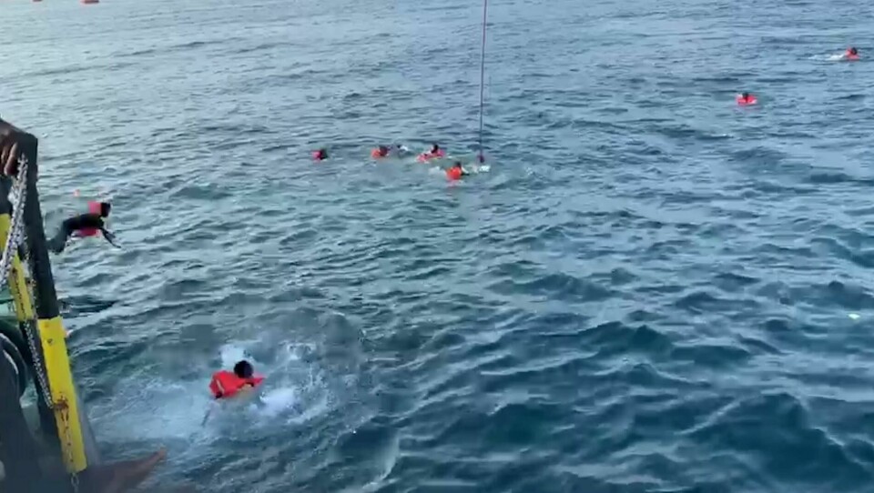 A migrant jumps overboard from Spanish rescue ship Open Arms and others swim away after more than 40 of them jumped from the ship to attempt to reach the coast, at sea near Palermo, Italy, in this still image taken from video, September 18, 2020. Open Arms/Handout via REUTERS ATTENTION EDITORS - THIS PICTURE WAS PROVIDED BY A THIRD PARTY. BEST QUALITY AVAILABLE A migrant jumps overboard from Spanish rescue ship Open Arms and others swim away after more than 40 of them jumped from the ship to attempt to reach the coast, at sea near Palermo, Italy, in this still image taken from video, September 18, 2020. Open Arms/Handout via REUTERS ATTENTION EDITORS - THIS PICTURE WAS PROVIDED BY A THIRD PARTY. BEST QUALITY AVAILABLE