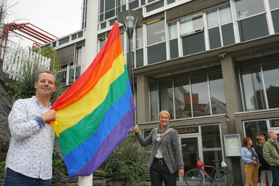 Ordfører Christine Sagen Helgø (H) og festivalsjef for Stavanger på Skeivå, Daniel Rayner, heiser regnbueflagget ved rådhuset i Stavanger. Foto: Stavanger kommune