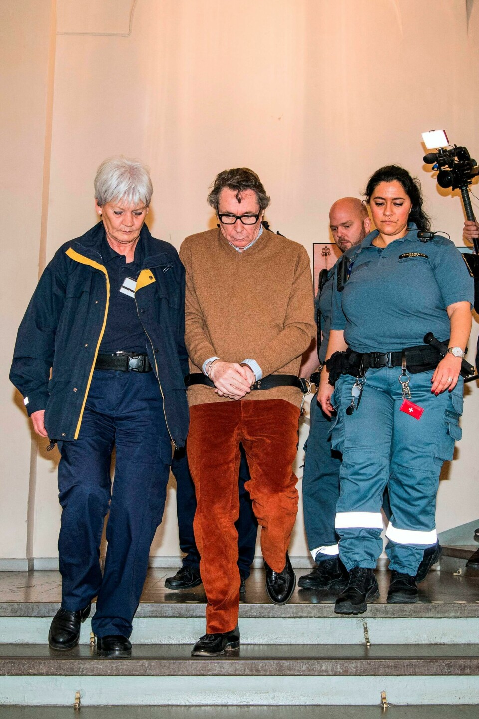 Frenchman Jean-Claude Arnault (C) is escorted out after the first day of his appeal trial on November 12, 2018 in Stockholm. - An appeals trial opens in Stockholm on Monday for a Frenchman jailed two years for rape in a scandal that led to the postponement of this year's Nobel Literature Prize. Once an influential figure in Stockholm's cultural scene, 72-year-old Jean-Claude Arnault was found guilty in October of raping a young woman in 2011 and sentenced to two years in prison. (Photo by Jonathan NACKSTRAND / AFP) Frenchman Jean-Claude Arnault (C) is escorted out after the first day of his appeal trial on November 12, 2018 in Stockholm. - An appeals trial opens in Stockholm on Monday for a Frenchman jailed two years for rape in a scandal that led to the postponement of this year's Nobel Literature Prize. Once an influential figure in Stockholm's cultural scene, 72-year-old Jean-Claude Arnault was found guilty in October of raping a young woman in 2011 and sentenced to two years in prison. (Photo by Jonathan NACKSTRAND / AFP)