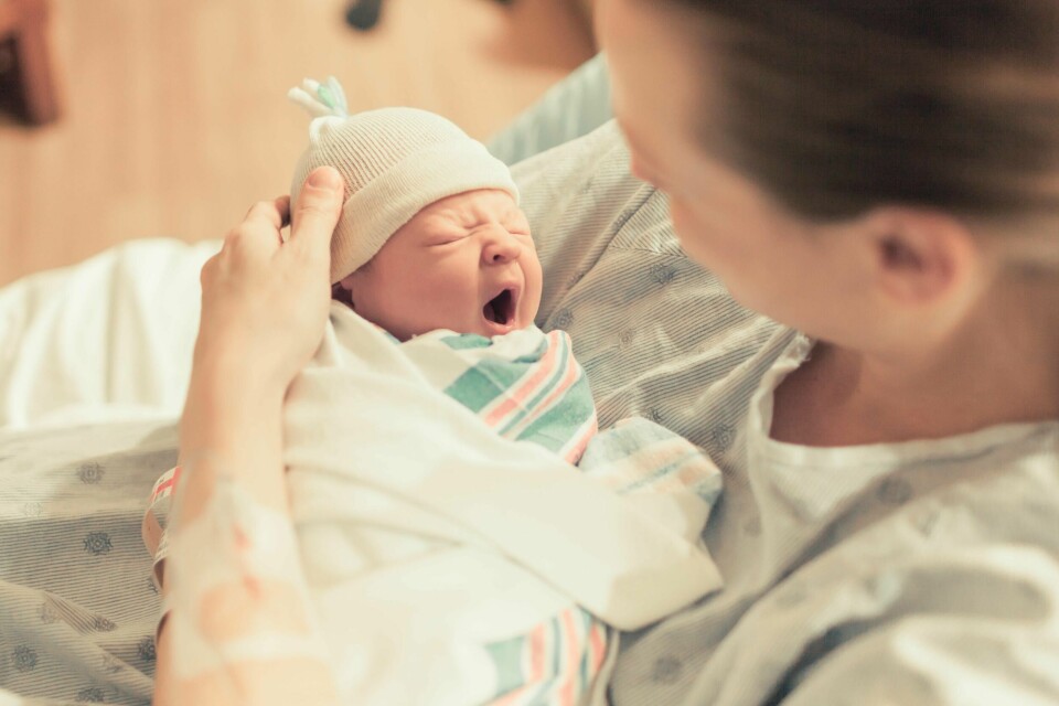 Mother in hospital holding her new born baby boy. Birth and new life.