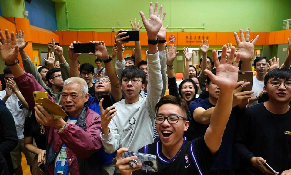 Tilhengere av den pro-demokratiske kandidaten Angus Wong jubler etter at han vant i sitt distrikt i lokalvalget i Hongkong søndag. Ifølge de foreløpige resultatene utklasser de pro-demokratiske kandidatene de mer Beijing-vennlige kandidatene.