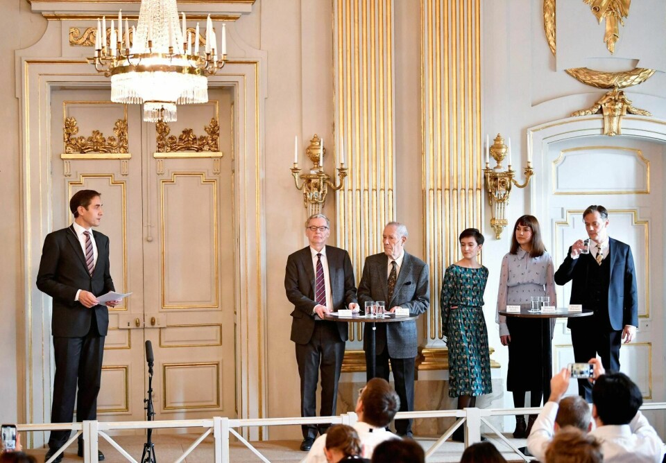 Svenska Akademiens såkalte «ständige sekreterare», altså leder, Mats Malm hadde ordet idet Nobelprisene i litteratur for 2018 og 2019 ble delt ut i fjor. Til høyre står de fem akademimedlemmene Anders Olsson, Pär Westberg, Rebecka Kärde, Mikael Blomqvist og Henrik Petersen Foto: Anders Wiklund/TT / NTB