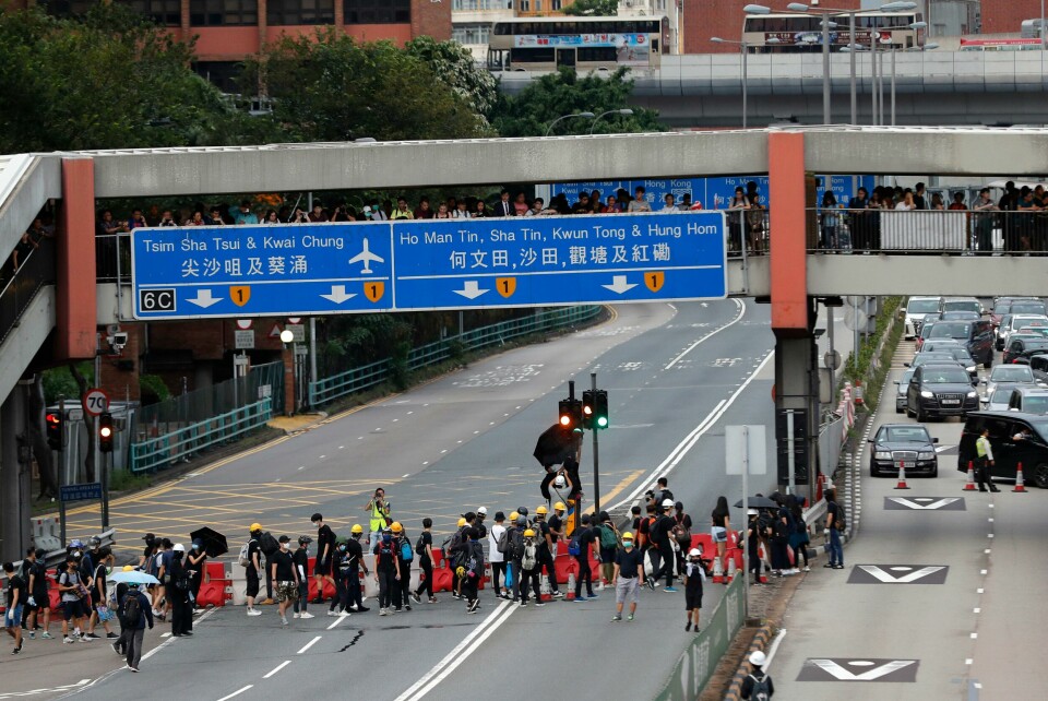 Protesters place barricades on a highway during a demonstration in Hong Kong, Saturday, Aug. 3, 2019. Hong Kong protesters ignored police warnings and streamed past the designated endpoint for a rally Saturday in the latest of a series of demonstrations targeting the government of the semi-autonomous Chinese territory. (AP Photo/Vincent Thian) Protesters place barricades on a highway during a demonstration in Hong Kong, Saturday, Aug. 3, 2019. Hong Kong protesters ignored police warnings and streamed past the designated endpoint for a rally Saturday in the latest of a series of demonstrations targeting the government of the semi-autonomous Chinese territory. (AP Photo/Vincent Thian)