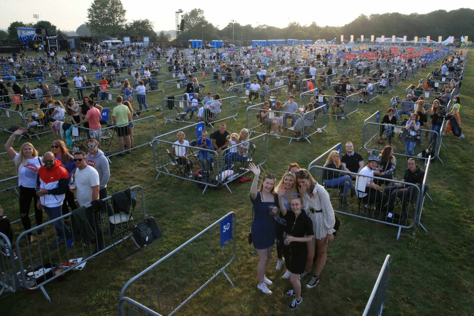 Fans occupy separate pens to force social distancing, ahead of the Sam Fender rock concert at the Virgin Money Unity Arena, a pop-up venue for the gig in Gosforth Park, Newcastle, northern England, Tuesday Aug. 11, 2020. Fans in groups of up to five people will watch the show from 500 separated zones at what the promoters say is the world's first socially-distanced COVID-19 gig. (Owen Humphreys/PA via AP)