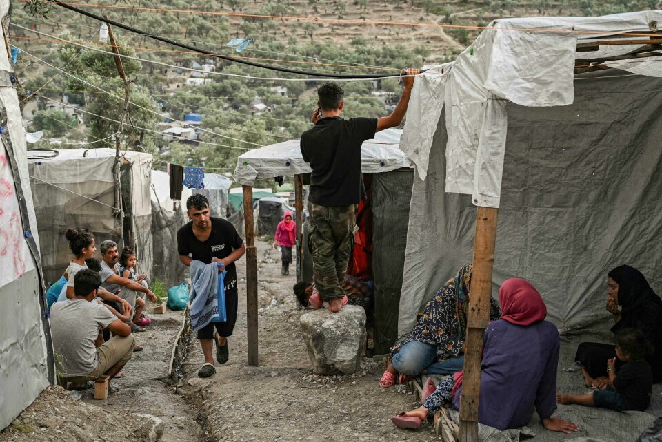 Refugees and migrants are pictured in a improvised tents camp near the refugee camp of Moria in the island of Lesbos on June 21, 2020. - Greece's announcement that it was extending the coronavirus lockdown at its migrant camps until July 5, cancelling plans to lift the measures on June 22, coincided with World Refugee Day on June 27, 2020. (Photo by ARIS MESSINIS / AFP) Refugees and migrants are pictured in a improvised tents camp near the refugee camp of Moria in the island of Lesbos on June 21, 2020. - Greece's announcement that it was extending the coronavirus lockdown at its migrant camps until July 5, cancelling plans to lift the measures on June 22, coincided with World Refugee Day on June 27, 2020. (Photo by ARIS MESSINIS / AFP)