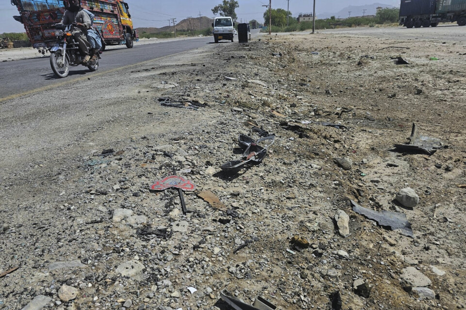 En motorsyklist og en buss kjører forbi stedet der en skolebuss ble rammet av et selvmordsangrep. Angrepet skjedde på en motorvei i utkanten av byen Khuzdar, i sørvestlige Pakistan onsdag. En motorsyklist og en buss kjører forbi stedet der en skolebuss ble rammet av et selvmordsangrep. Angrepet skjedde på en motorvei i utkanten av byen Khuzdar, i sørvestlige Pakistan onsdag. Foto: AP / NTB