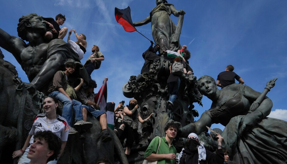 I Frankrike er for eksempel over 1000 arrestert og siktet for sin rolle i masseprotestene mot pensjonsreform. Her fra 1. mai i Paris. Protesters stand on a statue during the May Day demonstration, Thursday, May 1, 2025 in Paris. (AP Photo/Thibault Camus)
